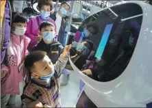  ?? ZHAI HUIYONG / FOR CHINA DAILY ?? Children interact with a Baidu robot during an expo in Wuzhen, Zhejiang province.