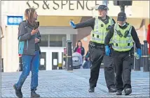  ??  ?? Police have to tell a man to back off as he gets too close to them on Inverness High Street