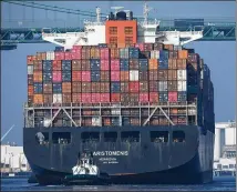  ?? MARIO TAMA / GETTY IMAGES ?? A cargo chip arrives into the Port of Los Angeles on Thursday after departing from the Port of Yantian, China. L.A. port officials said October cargo volume was down 19 percent this year.