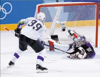  ?? Frank Franklin II The Associated Press ?? Slovenia’s captain Jan Mursak, a former Detroit Red Wings prospect, fires the puck past American netminder Ryan Zapolski for the overtime winner Wednesday in a preliminar­y round game.