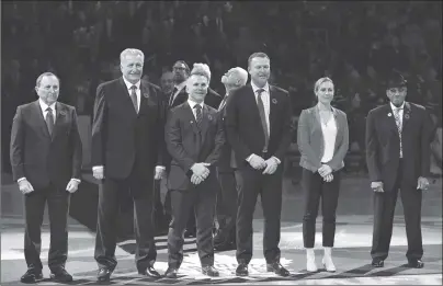  ?? CP PHOTO ?? NHL commission­er Gary Bettman, left, joins Hockey Hall of Fame inductees Alexander Yakushev, Martin St. Louis, Martin Brodeur, Jayna Hefford and Willie O’Ree for a ceremony prior to NHL action between the Toronto Maple Leafs and the New Jersey Devils in Toronto on Friday.