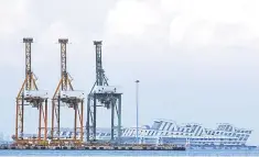  ?? – Reuters photo ?? Container cranes are pictured at the Port of Singapore. The broad-based gains built on last week’s advance as top officials from the world’s biggest economies work on an agreement to end their long-running tariffs spat, which was a major drag on markets at the end of 2018.