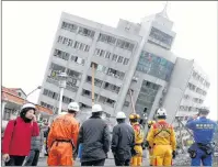  ?? AP PHOTO ?? Rescuers from Japan join the searching operation at an apartment building collapsed after a strong earthquake in Hualien County, eastern Taiwan, Friday.