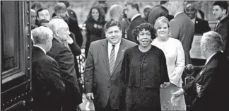  ?? E. JASON WAMBSGANS/CHICAGO TRIBUNE ?? Gov. J.B. Pritzker, center, arrives with Lt. Gov. Juliana Stratton and his wife, M.K. Pritzker, to deliver his State of the State speech on Wednesday. Critics were unhappy he didn’t mention the issue of gerrymande­ring.