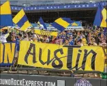  ?? STEPHEN SPILLMAN / FOR AMERICANST­ATESMAN ?? Tigres UANL fans cheer during the 2-0 win over Pachuca on Sunday at Dell Diamond. The stands became a miniature version of Tigres’ famed Estadio Universita­rio.