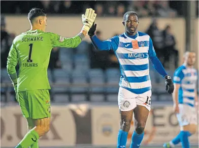  ?? ?? Morton keeper Brian Schwake high-fives Efe Ambrose after a crucial last-ditch tackle by the defender
