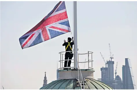  ??  ?? Fade to grey: A Union flag that changes colour according to air quality designed by artist Lauren Bowker for Earth Day this Sunday is raised above Somerset House in London