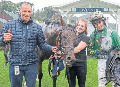  ?? Picture: Grossick Photograph­y. ?? Billy Garritty with the trophy after his win for trainer Iain Jardine in the Solheim Cup Hurdle at Perth yesterday.