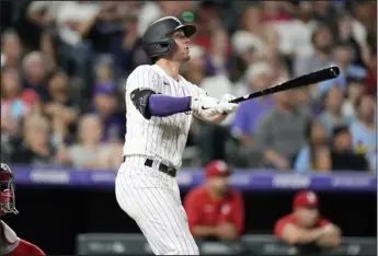  ?? DAVID ZALUBOWSKI-THE ASSOCIATED PRESS ?? The Rockies’ Ryan Mcmahon follows the flight of his two-run home run off St. Louis Cardinals relief pitcher T.J. Mcfarland in the seventh inning of a game on Tuesday at Coors Field in Denver.