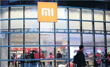  ?? Picture: Reuters ?? A man walks past a Xiaomi store in Shenyang, Liaoning province, in China.