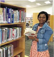  ??  ?? THE RIGHT PAGE: Thuli Hadebe manages the new Nkungumath­e library, an initiative of the youth developmen­t forum