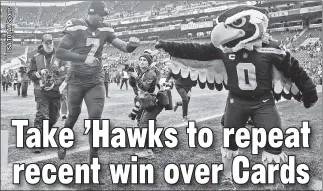  ?? ?? SEA’ HIM FLY! Seattle QB Geno Smith, celebratin­g last week’s win over the Giants with the Seahawks’ mascot, has been a catalyst behind the team’s surprising success.