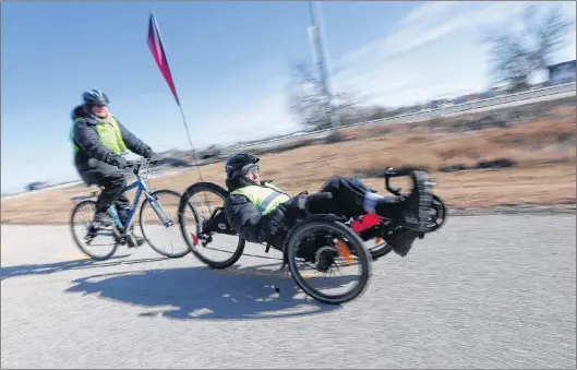  ?? CP PHOTO ?? Jill Oakes and her husband Rick Riewe speed along a bike trail in in Winnipeg.