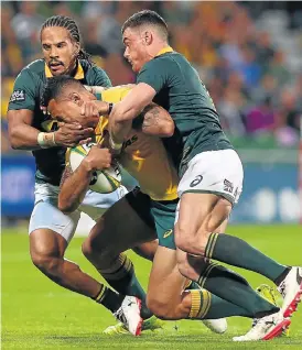  ?? /Paul Kane/Getty Images ?? Crunch time: Bok wing Courtnall Skosan, left, and centre Jesse Kriel stop Australian fullback Israel Folau in his tracks in Perth on Saturday.