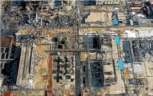  ?? AP ?? Damaged buildings are seen at the site of a factory explosion in a chemical industrial park in Xiangshui County of Yancheng in eastern China’s Jiangsu province that killed dozens and seriously injured many.