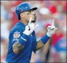  ?? GARY LANDERS/AP ?? Javier Baez reacts after hitting a grand slam off Cincinnati Reds relief pitcher Jared Hughes.