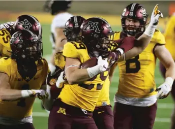  ?? STACY BENGS/AP ?? Linebacker Josh Aune reacts Friday after his intercepti­on in the finalminut­e cemented Minnesota’s win.