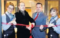  ??  ?? ●●Council leader Alex Ganotis cuts the ribbon to open the new Holiday Inn Express Stockport with staff team members, from left, Sarah Parker, manager Carl Butterwort­h and Jessica Meadows