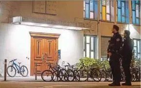  ?? AFP PIC ?? Police officers guarding a synagogue in Zurich recently after an Orthodox Jewish man was stabbed.