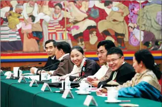  ?? FENG YONGBIN / CHINA DAILY ?? Deputies to the 13th National People’s Congress from the Tibet autonomous region attend the delegation’s plenary meeting on Wednesday in Beijing.