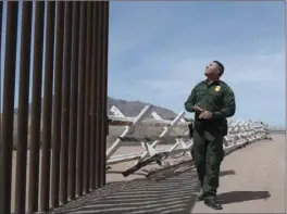  ??  ?? On April 25, Border Patrol agent Justin Castrejon explains how Normandy-style vehicle barriers placed near Mount Signal is used to stop immigrant smugglers. VINCENT OSUNA FILE PHOTO