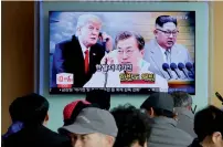 ?? AFP ?? A TV screen shows images of US President Donald Trump, South Korean President Moon Jae-in and North Korean leader Kim Jongun at a Seoul Railway Station on Wednesday. —