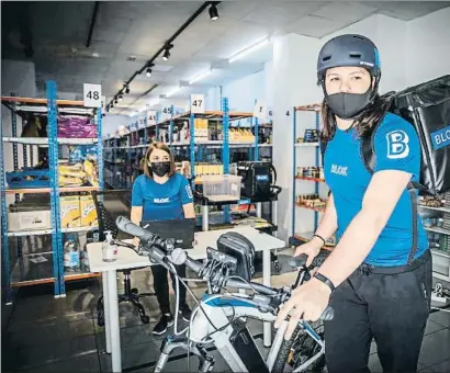  ?? LLIBERT TEIXIDÓ ?? Dos treballado­rs organitzen les comandes en un súper fantasma de l’empresa Blok ubicat a la Via Augusta