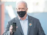  ?? DARRYL DYCK THE CANADIAN PRESS FILE PHOTO ?? B.C. Premier John Horgan shows his provincial COVID-19 vaccinatio­n card in September. Ottawa first began working on a national vaccine passport this spring.