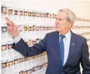  ?? ANDREW HARNIK/ASSOCIATED PRESS ?? Rep. Walter Jones, R-N.C., points to one of many photograph­s near his Capitol Hill office of soldiers killed in action.