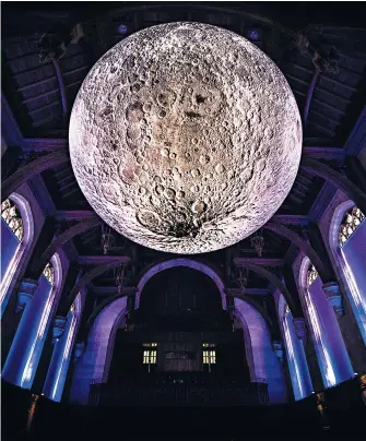  ??  ?? Close orbit Artist Luke Jerram’s installati­on Museum of the Moon, a giant replica of the Earth’s satellite, hangs in the University of Bristol Great Hall, Wills Memorial Building. The 7-foot-wide structure features detailed Nasa imagery and is free to...