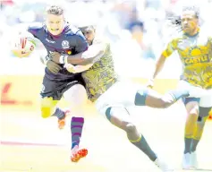  ??  ?? Scotland’s Max Mcfarland (left) is tackled by South Africa’s Siviwe Soyzwapi (right) during the quarter final between Scotland and South Africa on the second and last day of the Rugby Sevens tournament at the Cape Town Stadium in Cape Town. — AFP photo