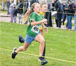  ?? DESIREE ANSTEY/JOURNAL PIONEER ?? It takes grit and determinat­ion for Maggie Gamble, left, representi­ng Alberton Elementary School, and Megan Mossey from Spring Park Elementary in Charlottet­own to sprint to the finish line.