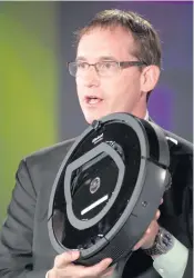  ?? DAVID PAUL MORRIS Bloomberg News file, 2013 ?? Colin Angle, chairman, chief executive officer and co-founder of iRobot Corp., displays an iRobot Roomba robot during the Bloomberg Next Big Thing Summit.