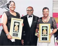  ??  ?? Minister of Tourism Edmund Bartlett is flanked by the national champion in the individual category, Mikailla Robinson, of The Jamaica Pegasus (left) and national champion in the organisati­on category, Betty-Ann Brown of the Hyatt Ziva and Zilara,...
