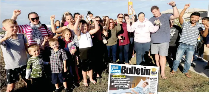  ?? Picture: MIKE BATTERHAM ?? Parents celebrate outside Pimpama State Primary College after news the school will finally get a pedestrian crossing. Left: Riley Haydon on our front page yesterday.