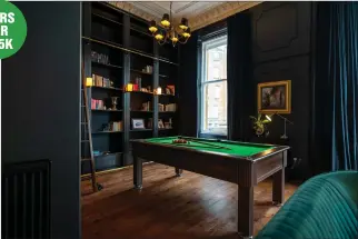  ?? ?? Highlights include a striking en suite bathroom, right, a library bookcase wall complete with ladder rail, above, and a semi open plan dining kitchen, left