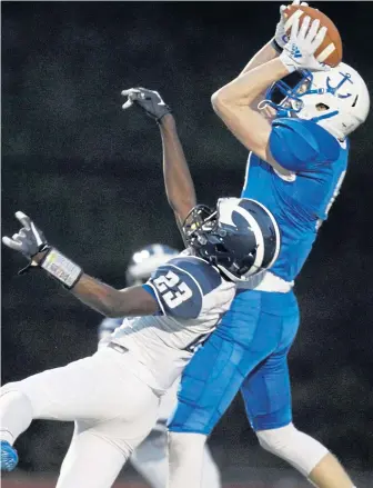  ?? PAUL CONNORS / BOSTON HERALD ?? OVER THE TOP: Scituate’s Max Roche makes a catch over Swampscott’s Andrew Augustin during the Div. 5 state final.