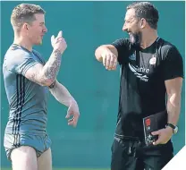  ??  ?? Derek McInnes shares a joke with Jonny Hayes during Aberdeen’s training break in Dubai.