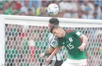  ?? ?? ARGENTINAS’s Enzo Fernandez going against Mexico’s Hector Moreno (15).