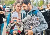  ?? AFP ?? A man welcomes Anna Zaitseva and her son Svyatoslav, 6 month old, after arriving from Mariupol, in Zaporizhzh­ia.