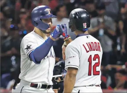  ?? John Minchillo Associated Press ?? TEXAS’ JOEY GALLO, left, is congratula­ted by American League teammate Francisco Lindor after Gallo’s solo home run in the seventh inning gave the AL a 4-1 lead. Gallo and the National League’s Charlie Blackmon hit the only two home runs of the game.