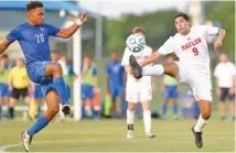  ?? STAFF PHOTO BY ROBIN RUDD ?? McCallie’s Logan Russell, left, and Baylor’s Matheus Maia fight for control of the ball Wednesday night in the Division II-AA title game.