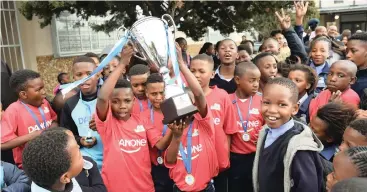  ?? PHANDO JIKELO African News Agency/ANA ?? Pupils from Nomlingani­selo Primary School received a rousing welcome from teachers and parents after winning the 2018 Danone Nations Cup champions. They arrived from Johannesbu­rg yesterday and will compete in Spain next year. |