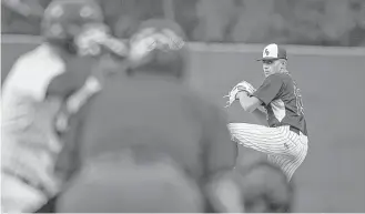  ?? Jerry Baker ?? Klein Oak righthande­r Devon Patel, right, eyes his target in the fourth inning Friday night. The junior struck out a dozen batters over a five-inning stint in a bi-district win over Aldine Davis.