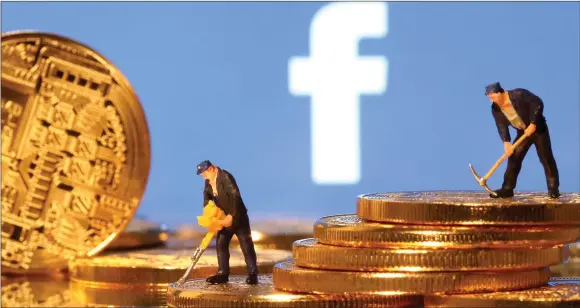  ?? — aado Ruvic photo ?? Small toy figures stand on representa­tions of virtual currency in front of the cacebook logo in this illustrati­on picture.