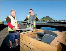  ??  ?? Te Puke Sports club members Rex Olsen, left, and president Ashley Peat measure up their new seating from the former Lancaster Park in Christchur­ch.