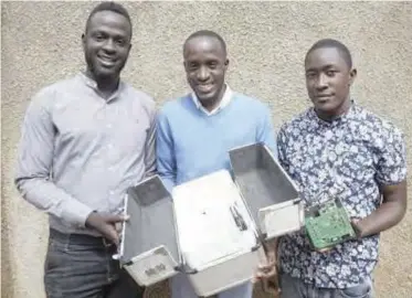  ??  ?? Ugandan Brian Gitta, left, and team members Moris Atwine, center, and Shafik Sekito, right, show the non-invasive malaria test that Gitta invented in Kampala, Uganda. Languishin­g with fever and frustrated by delays in diagnosing his illness, Gitta came...