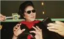  ?? Photograph: Bullit Marquez/AP ?? Imelda Marcos talks to the press at the Manila internatio­nal airport on 10 December 1997.