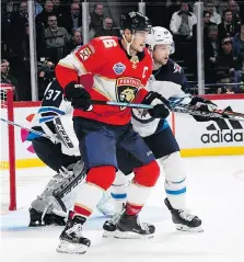  ??  ?? Florida Panthers centre Aleksander Barkov and Winnipeg Jets defenceman Josh Morrissey grapple for position in front of the Winnipeg net Thursday in Helsinki. Barkov, a native of Finland, had an assist in his team’s loss.