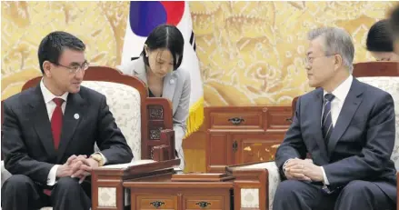  ??  ?? South Korean President Moon Jae-in with Japanese foreign minister, Taro Kono, left, prior to their meeting at the presidenti­al house on April 11, 2018.